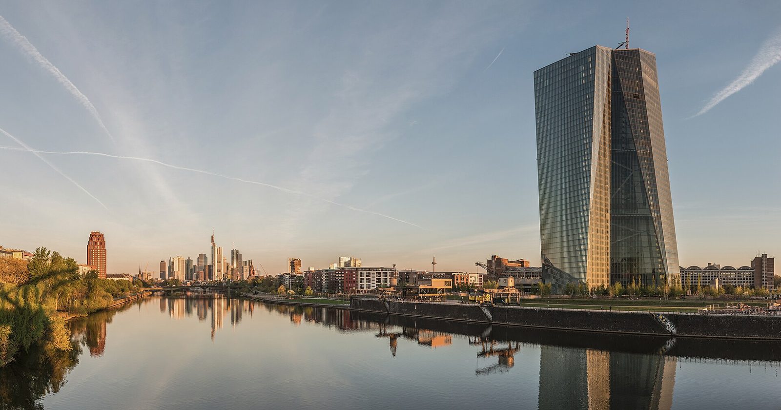 The seat of the European Central Bank against the Frankfurt skyline at dawn