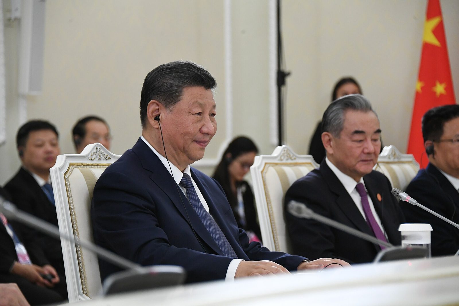 Xi Jinping seated with Chinese officials at a meeting during the 2024 BRICS summit in Kazan
